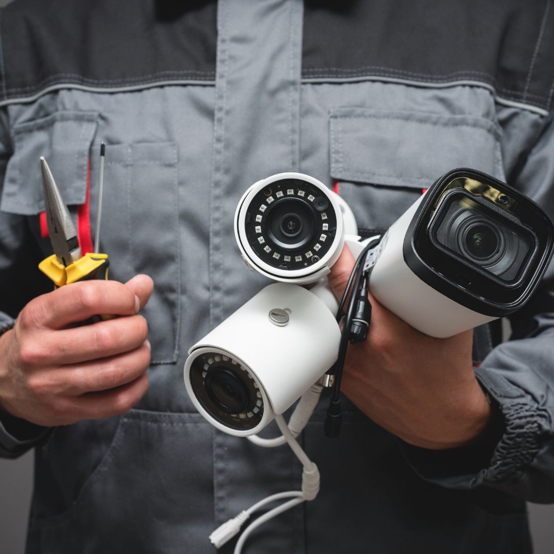 Security technician holding CCTV cameras